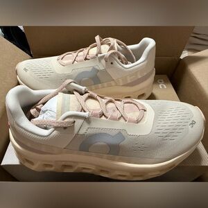 On Running Cream and Pink Athletic Shoes